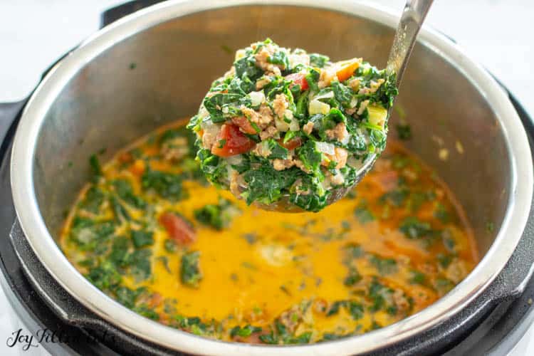 Instant Pot filled with keto Zuppa Toscana. Ladle of soup filled with greens, ground sausage and tomatoes