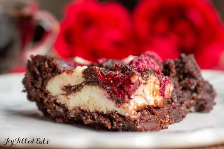Dark Chocolate Raspberry Cheesecake Brownie sitting on a plate