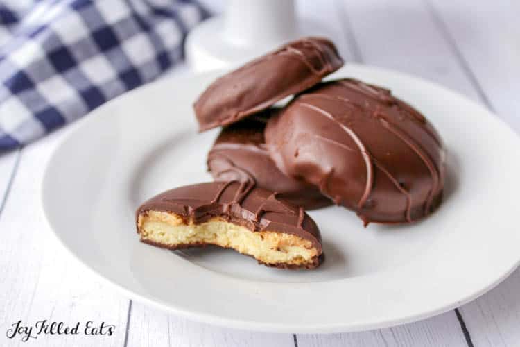 Plate of Tagalong cookies with one cookie cut in half with a bite missing