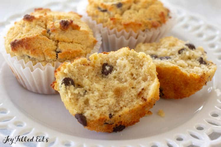 close up of three almond flour banana muffins with one muffin cut in half on a white plate