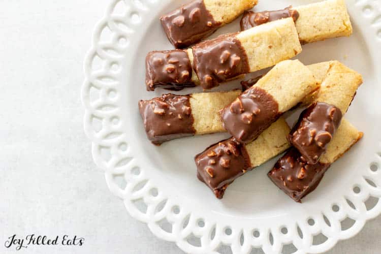Keto Almond Shortbread Cookies dipped in chocolate on a white plate