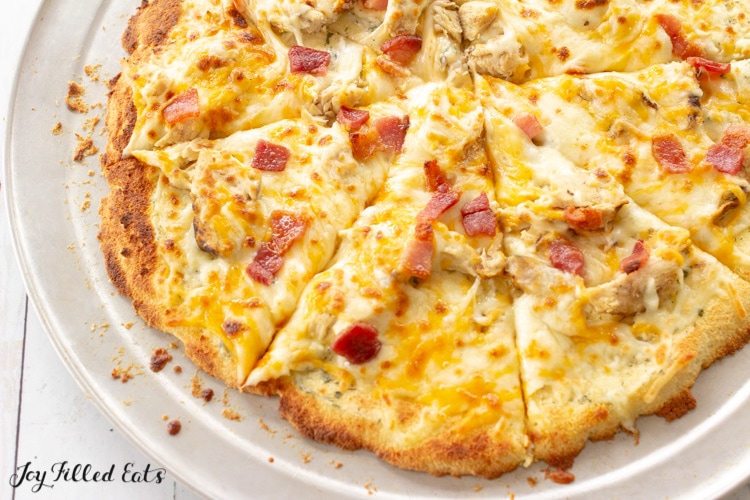 Chicken Bacon Ranch Pizza cut into slices on a pizza plate