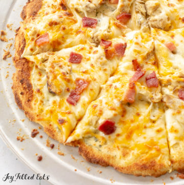 thin crust Keto Chicken Bacon Ranch Pizza on round silver plate