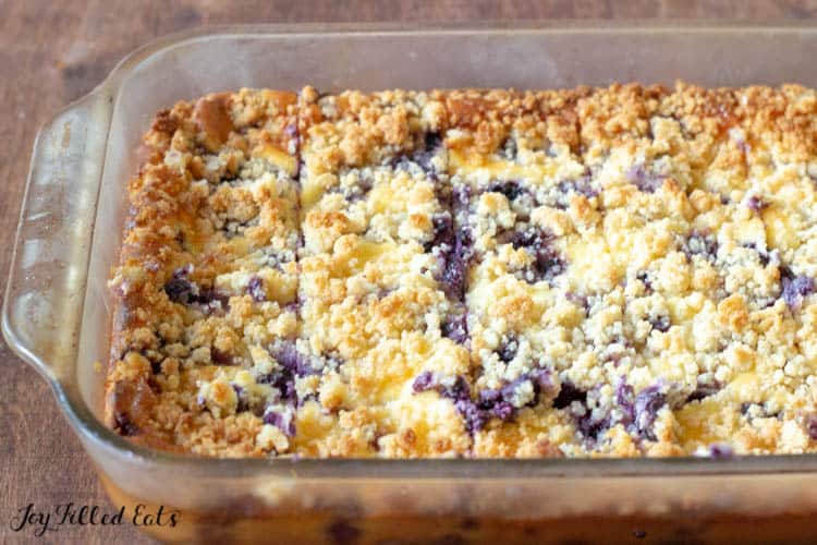 Baking dish of Lemon Blueberry Cheesecake Crumb bars cut into squares