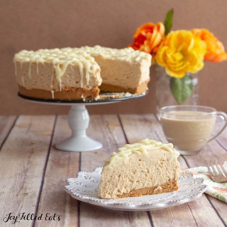 cake stand with peanut butter cheesecake on it and a slice on a plate