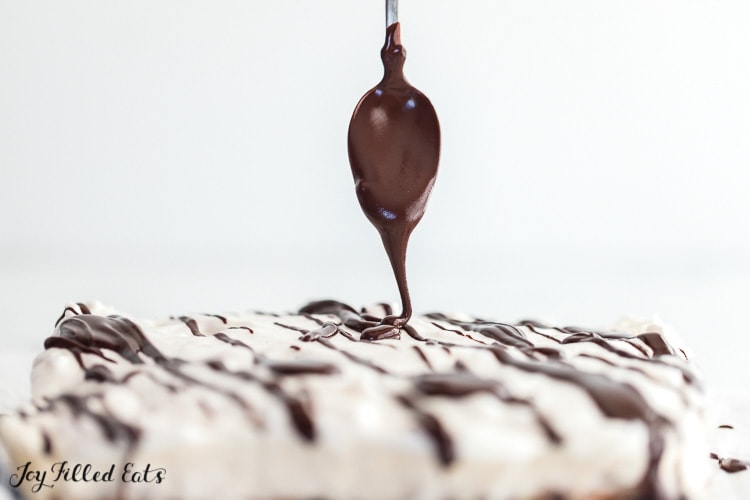chocolate being drizzled on the keto smores