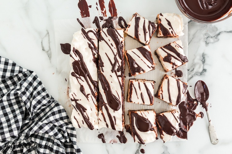 smores bars cut into squares and drizzled with chocolate