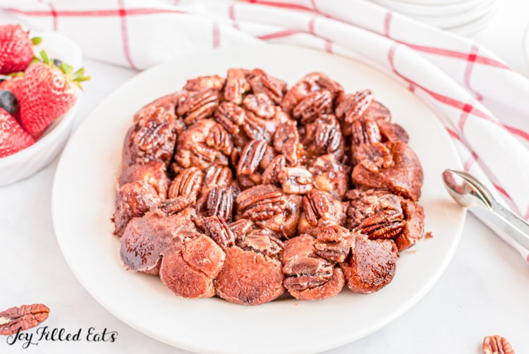 plate of keto monkey bread with pecans and caramel sauce