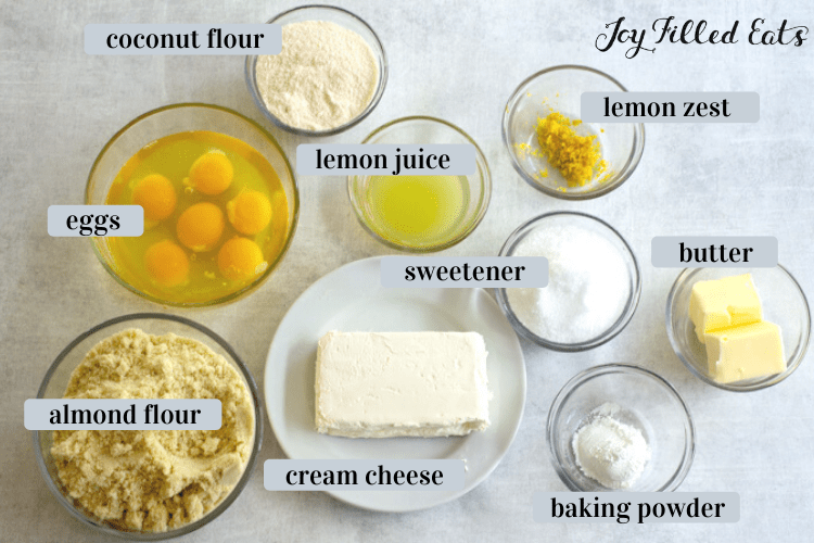 bowls of ingredients including coconut flour, lemon juice, eggs, lemon zest, butter, sweetener, cream cheese, baking powder and almond flour