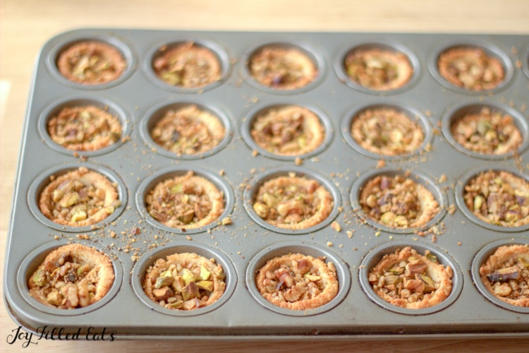 the baked baklava cookies in a mini muffin tin