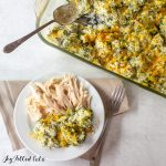 keto broccoli casserole in a glass baking dish and on a plate with chicken