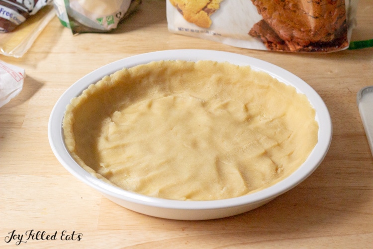 dough pressed into a round baking plate