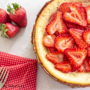 cheesecake topped with sliced strawberries