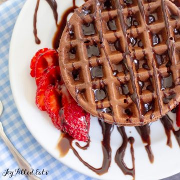 overhead shot of a chocolate chaffle drizzled with syrup