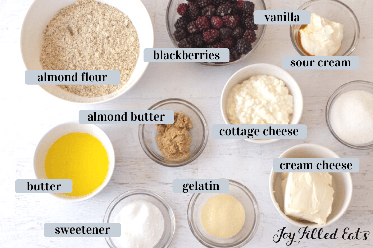 ingredients in small bowls such as almond flour, butter, sweetener, and cream cheese