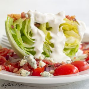 close up of a lettuce wedge salad with keto blue cheese dressing