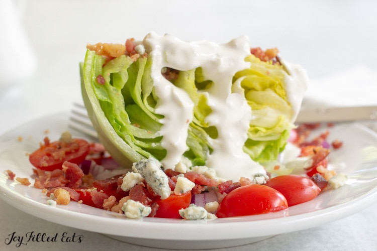 wedge of iceberg lettuce topped with keto blue cheese dressing
