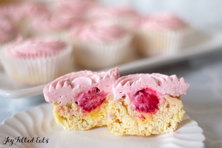 a raspberry lemonade cupcake cut in half on a plate