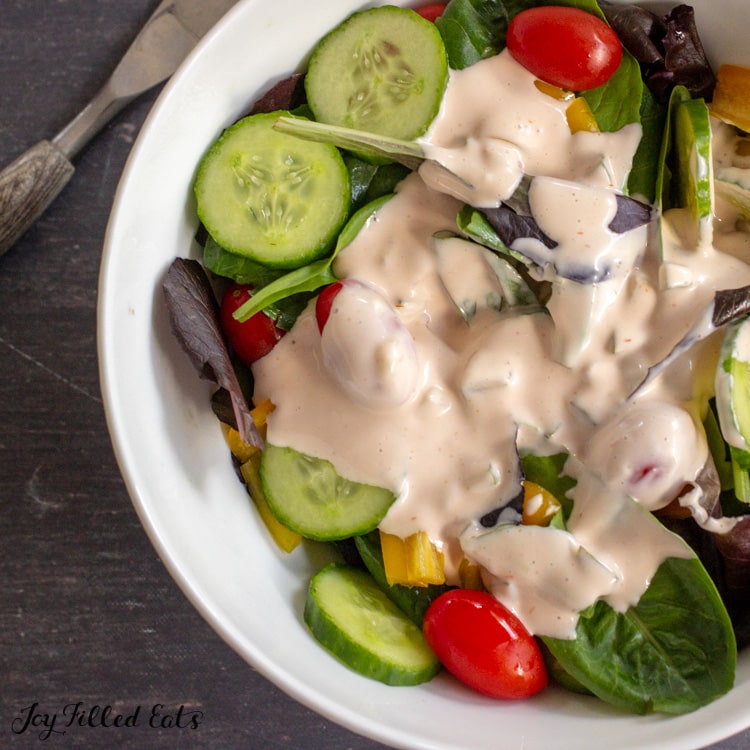 close up of dressing on salad
