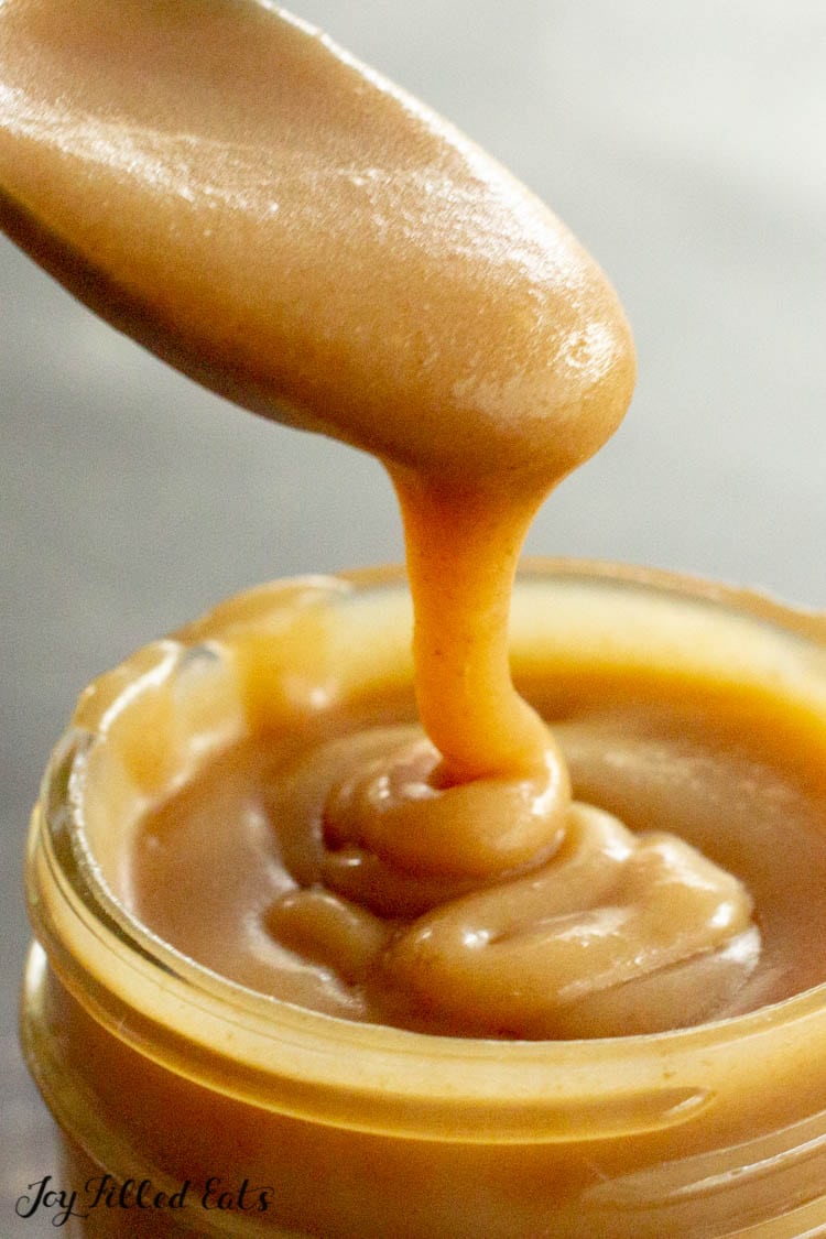keto caramel sauce dripping off a spoon