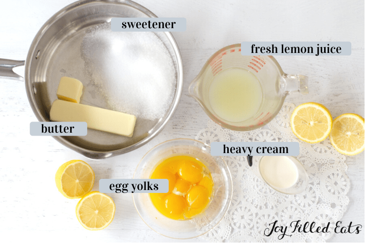 a saucepan with butter and sweetener and small measuring cup with lemon juice and cream, bowl of egg yolks