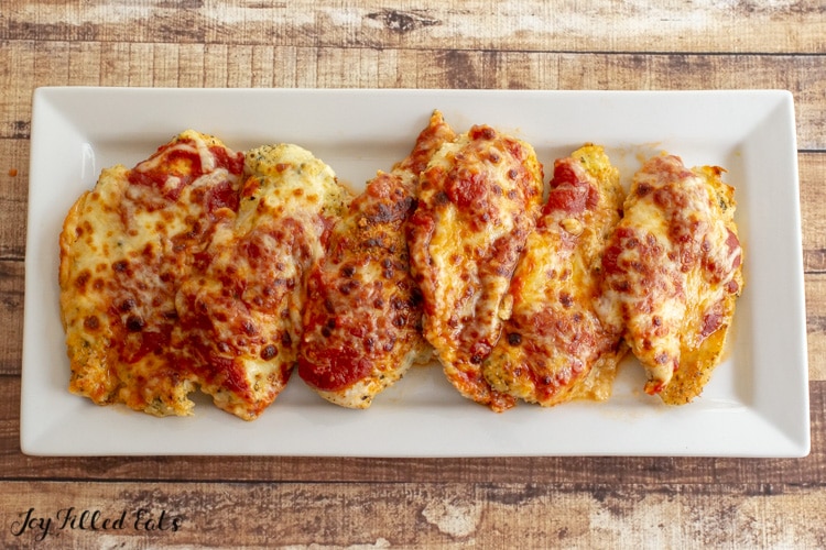 white rectangular plate with pieces of chicken parmesan