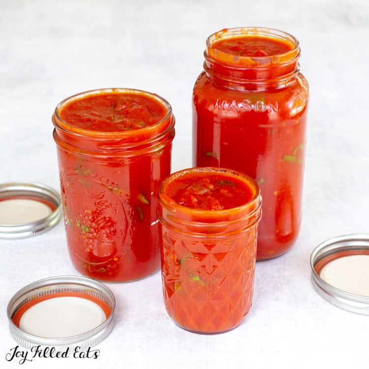 side shot of 3 mason jars of keto marinara sauce of varying sizes