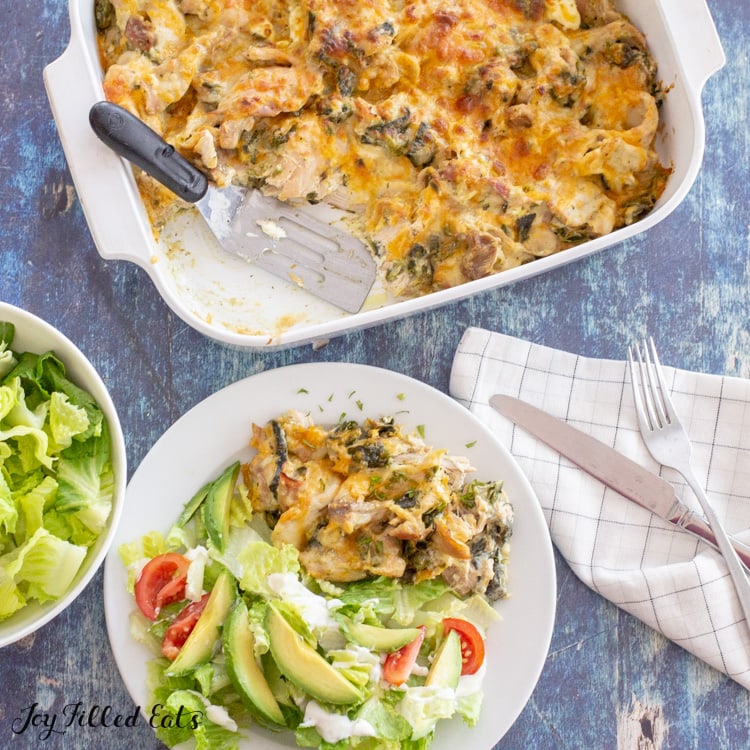 a serving of keto chile relleno casserole on a white plate with salad