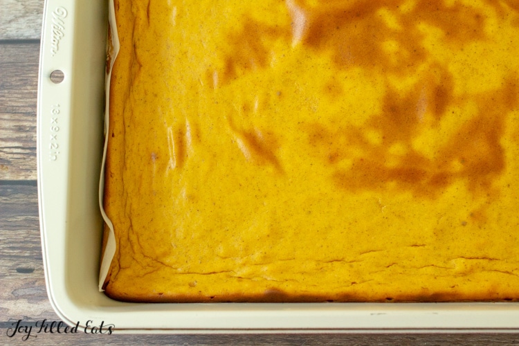 the baked keto pumpkin cheesecake bars in the pan