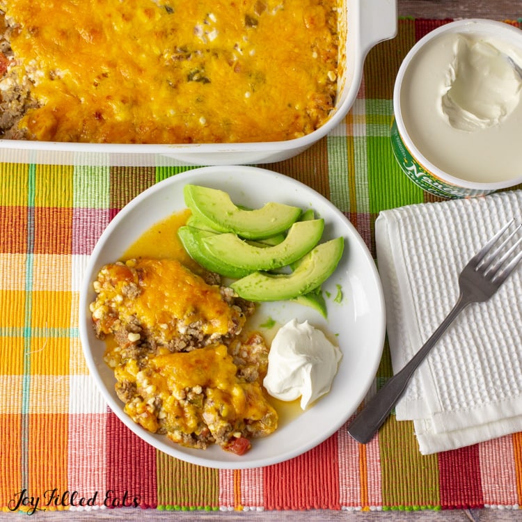 overhead square shot of keto taco casserole and a serving on a plate