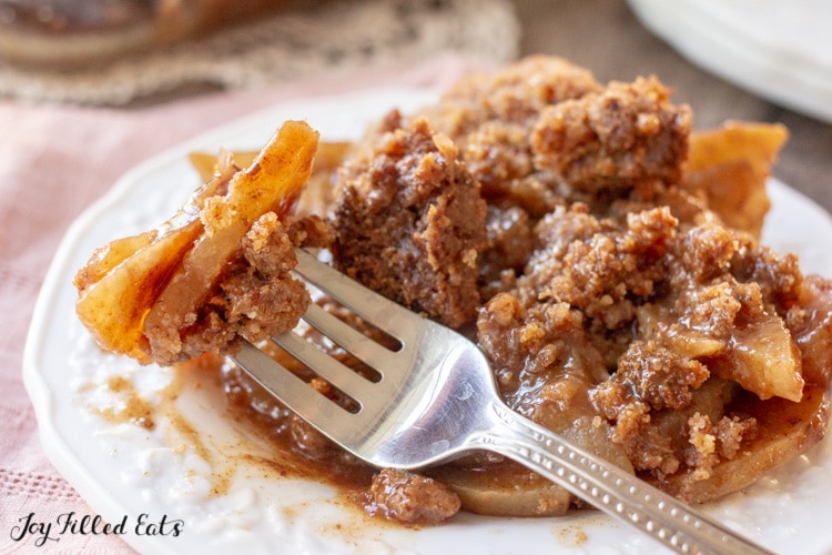 a fork lifting up a bite of the keto apple crisp