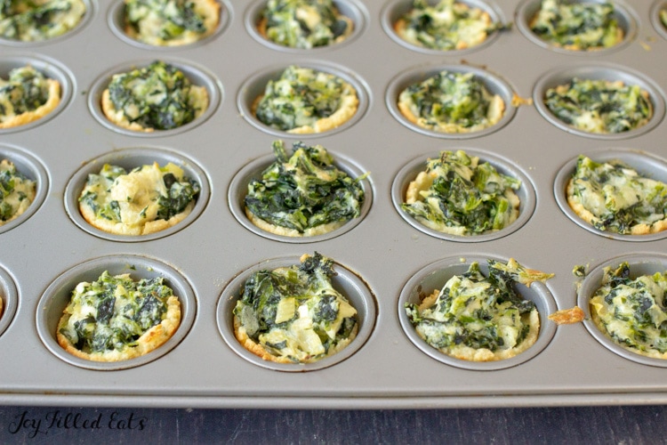 baked keto spinach artichoke dip bites in a mini muffin tin