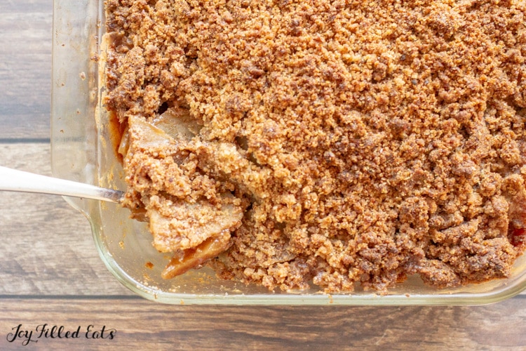 a spoon in a baking dish of low carb apple crisp
