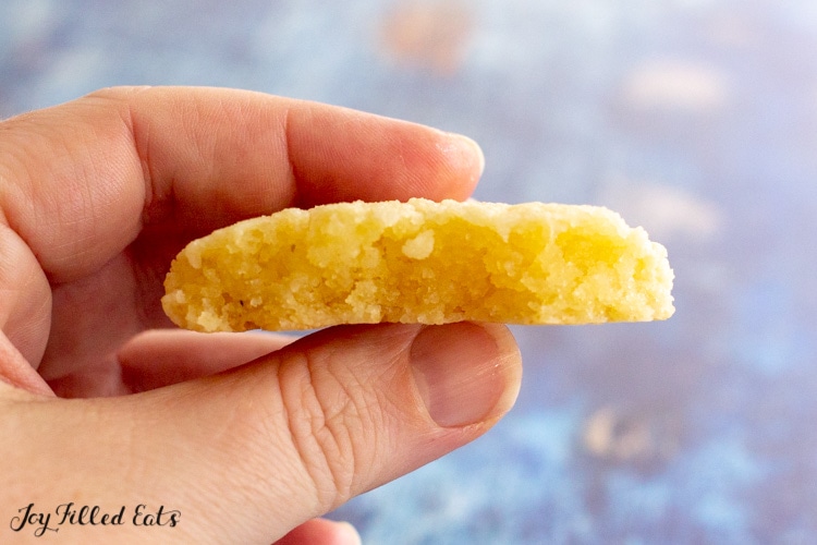 a hand holding half of one of the keto butter cookies