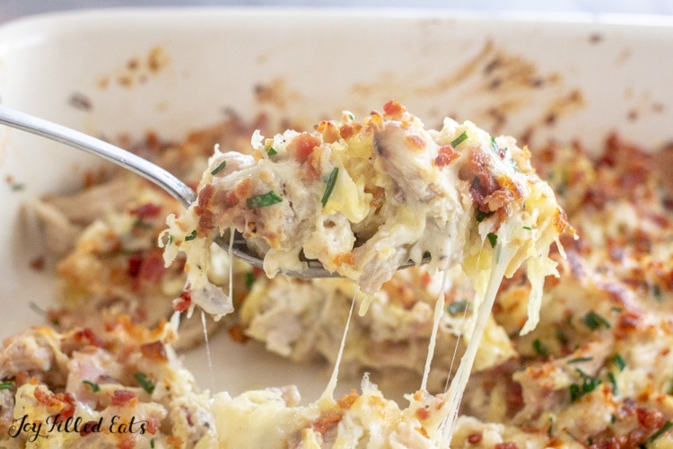 a spoon lifting up some of the keto creamy chicken casserole