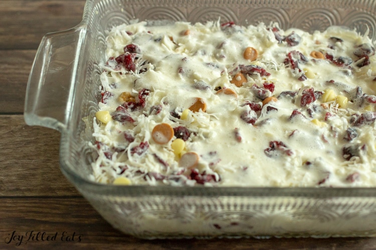 the white chocolate cranberry seven layer bars ready to be baked