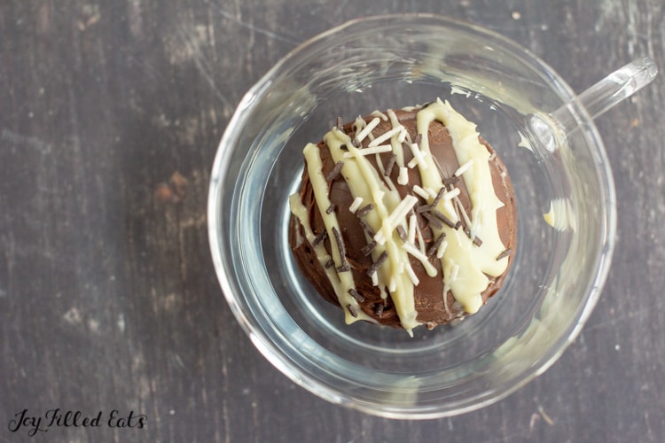 keto hot chocolate bombs with sprinkles in a glass mug