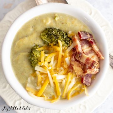 close up shot of keto broccoli cheese soup topped with bacon and cheese