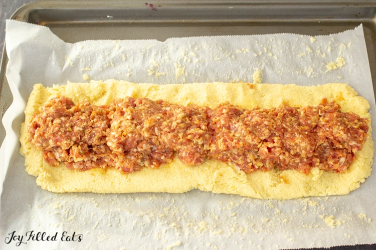 sausage filling on top of a long rectangle of dough