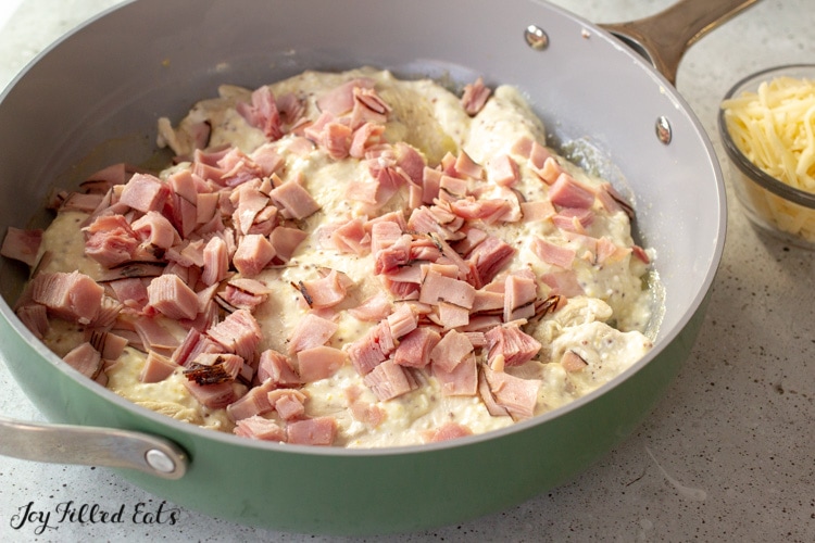 skillet with chicken, ham, and cheese