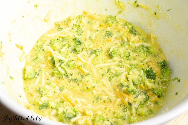 close up of broccoli and cheddar mixture in a mixing bowl