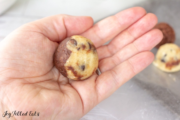 hand holding a keto cookie dough brownie fat bombs without chocolate coating