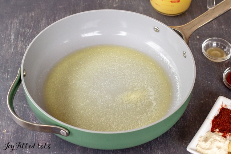large skillet with melted butter