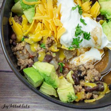 close up of a bowl of turkey taco chili with toppings