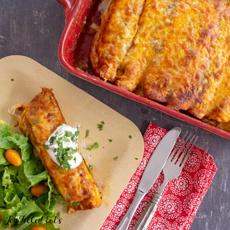 overhead shot of keto chicken enchiladas in a baking dish and served on a plate