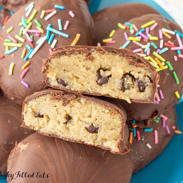 sugar free cookie dough egg cut in half on a plate of more cookie dough eggs