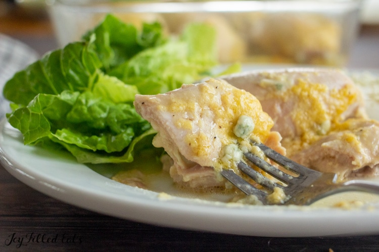 close up of a bite of chicken on a fork