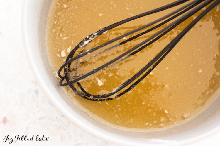 whisk in small saucepan with golden liquid