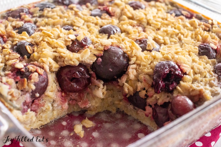 glass dish of baked cherry oatmeal missing a piece