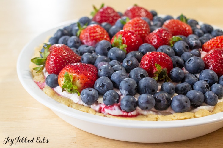 close up of cottage cheese cheesecake topped with berries
